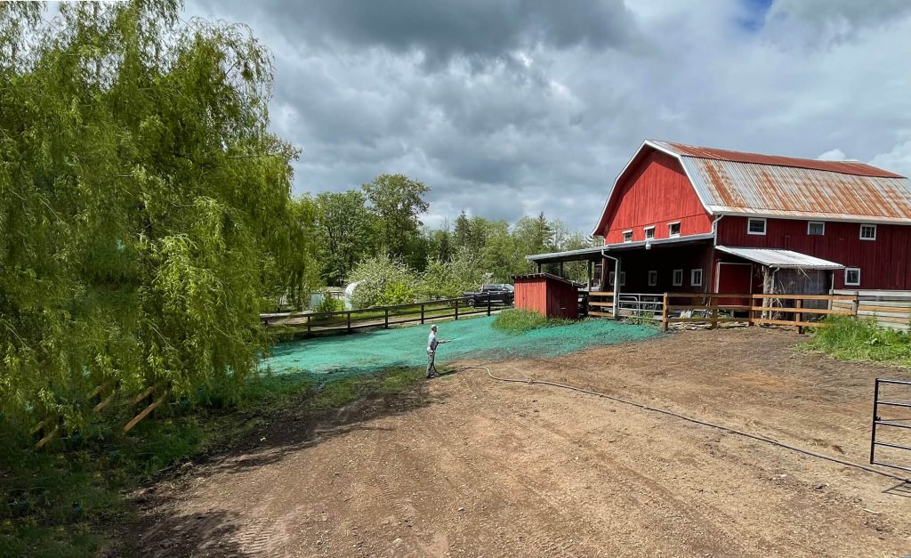 spray on grass seed Canada hydroseeding working spraying grass seed on farm